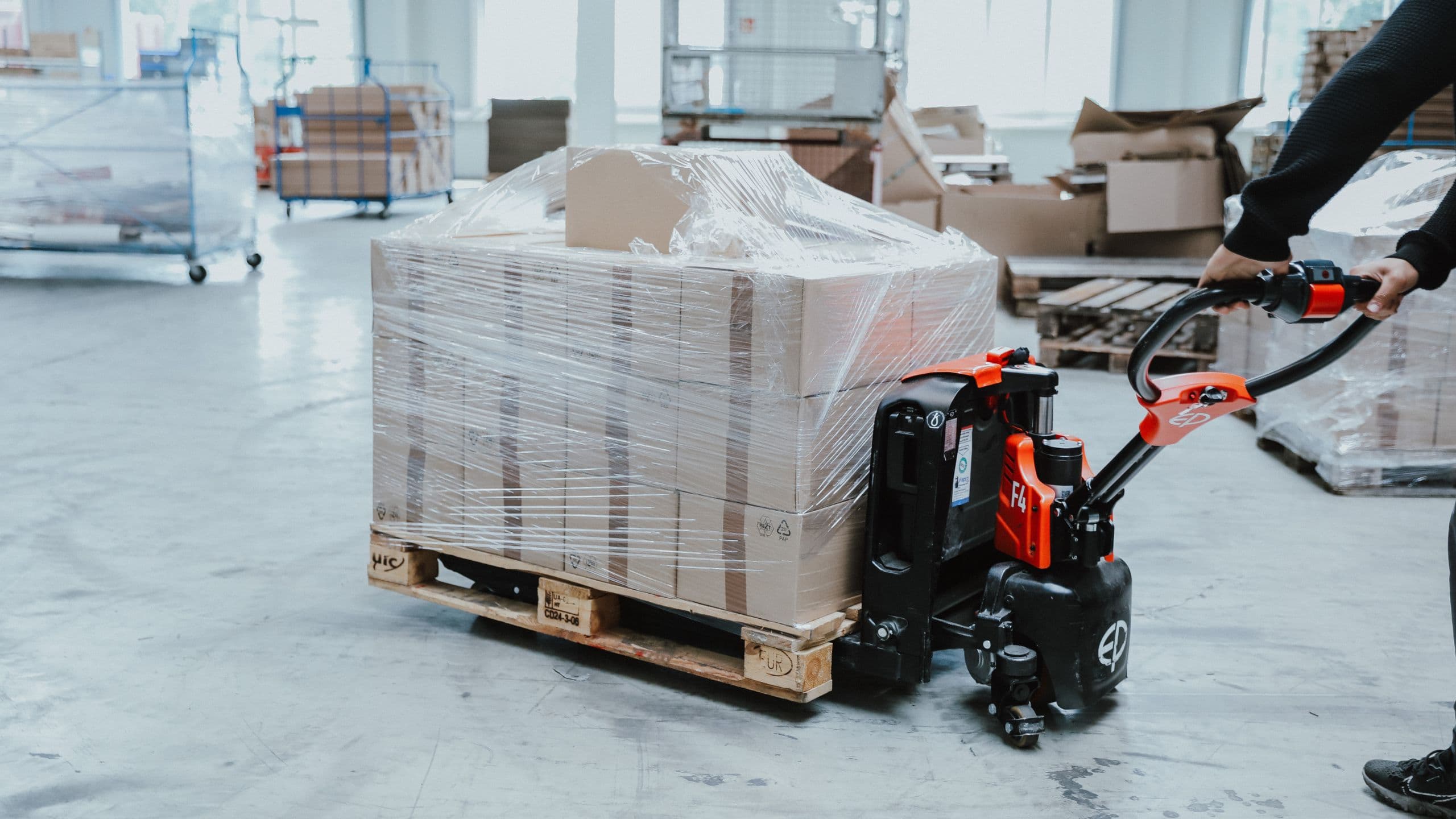 Palletized goods are received by electric pallet truck