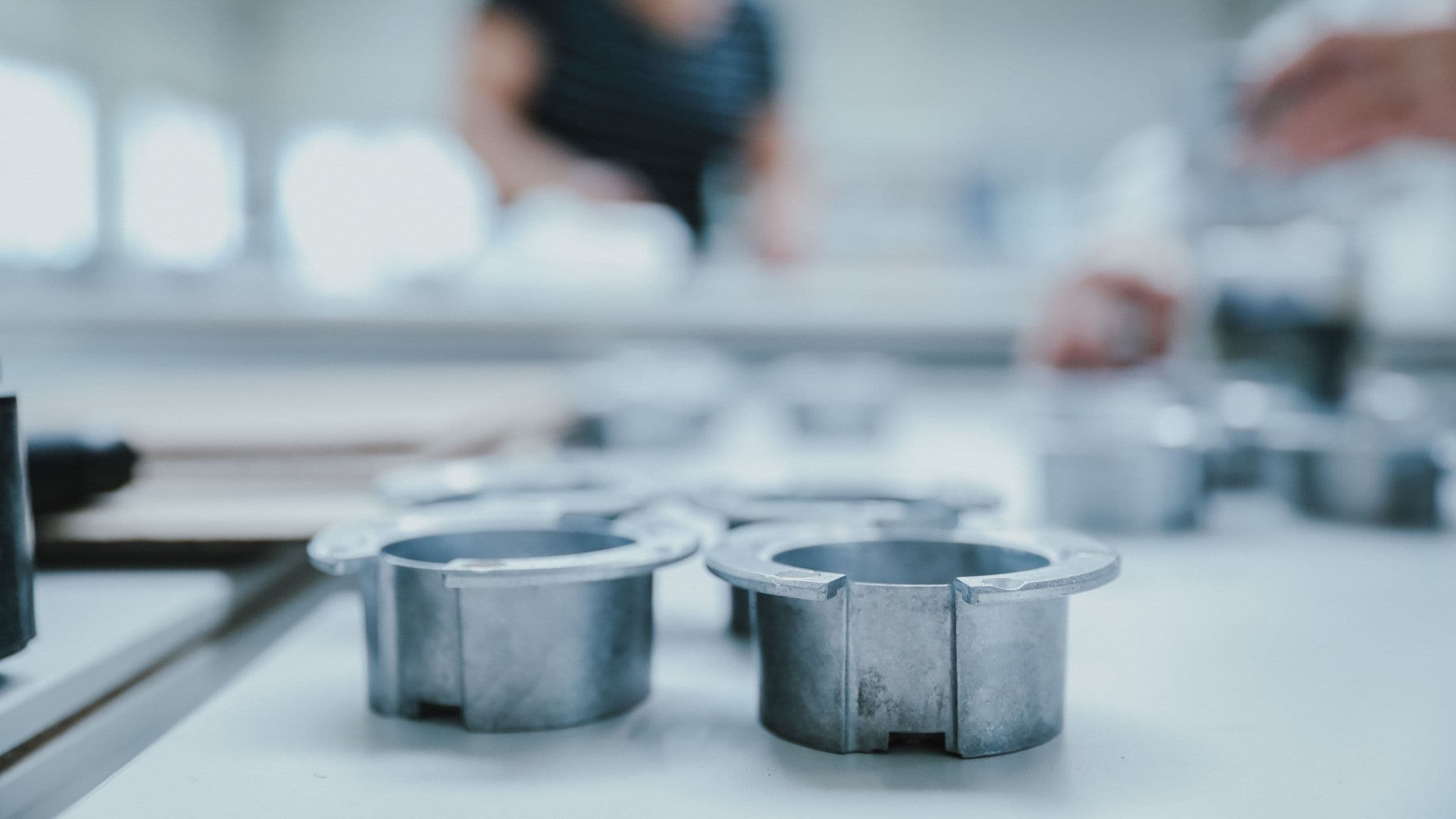 Industrial metal parts on an inspection table at BKM